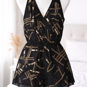 Adelyn Rae Black Romper with Gold Accents Size Medium.